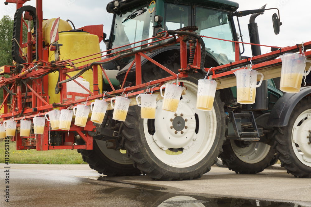 Fototapeta premium Tractor spray nozzle adjustment