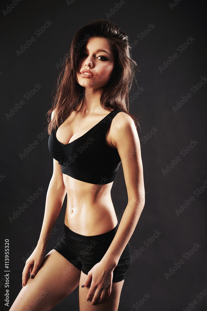 Obraz premium beautiful woman with the red boxing gloves,black background