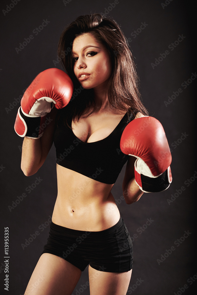 beautiful woman with the red boxing gloves,black background