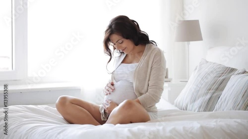 happy pregnant woman touching her tummy at home 10