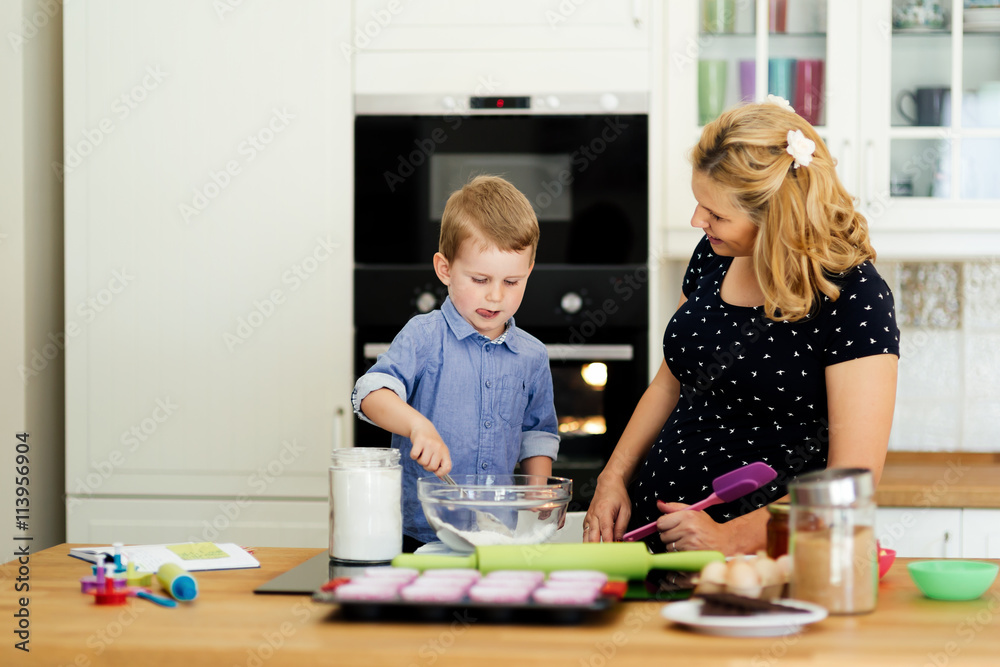 Beautiful child and mother baking Beautiful child and mother baking