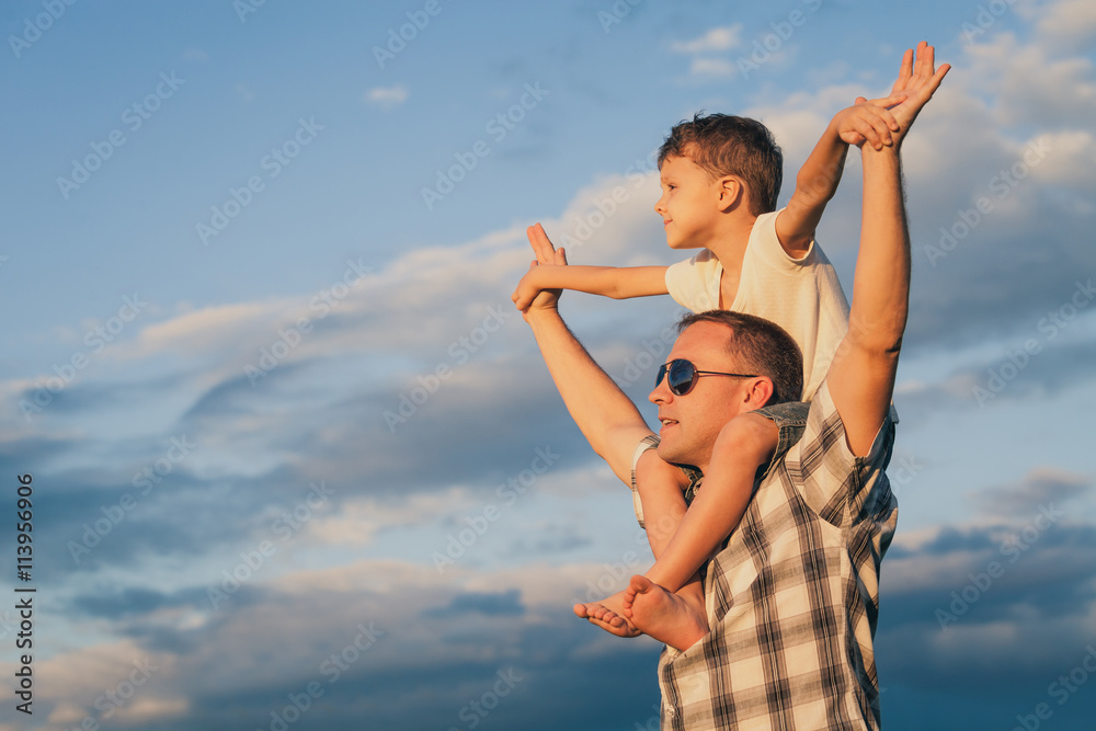 Father and son playing on the beach at the day time. Father and son playing on the beach at the day time.