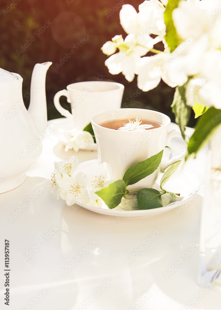 Close up on jasmine tea with jasmine flower in a glass cup. Tea