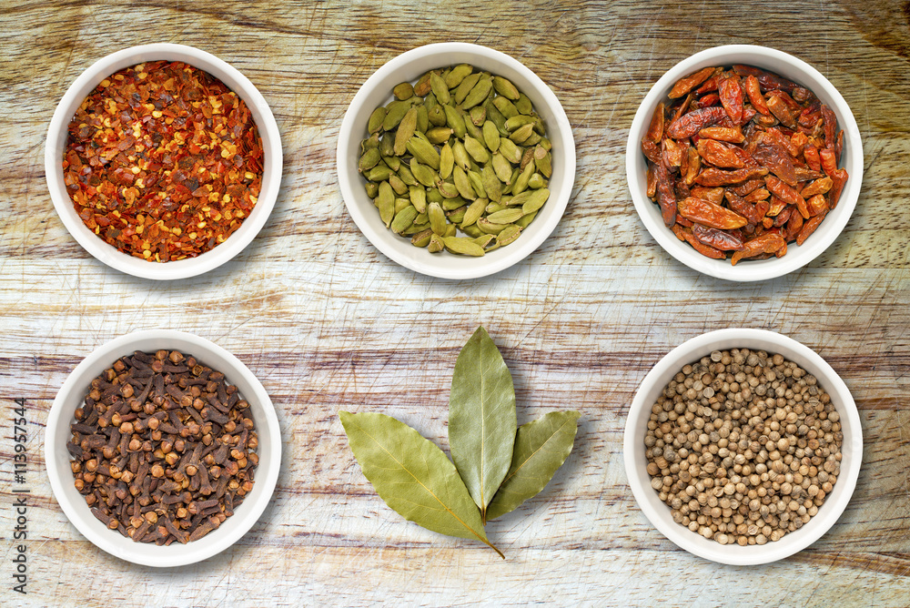 Spices in Pots on Old Wooden Chopping Board