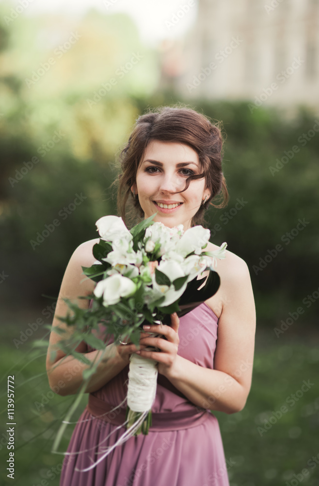 Beautiful bride, girl outdoors posing with bouquet Beautiful bride, girl outdoors posing with bouquet