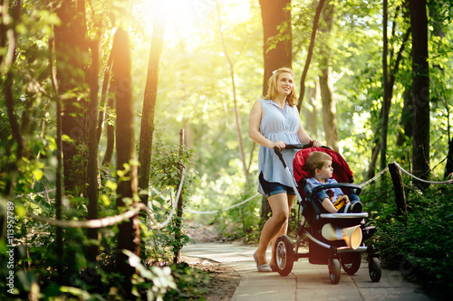 Pregnant woman walking with child in nature