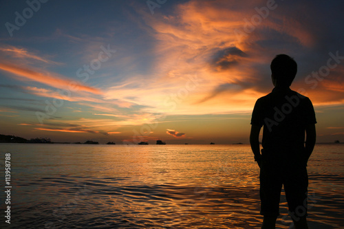 silhouette of man at sunset on the beach