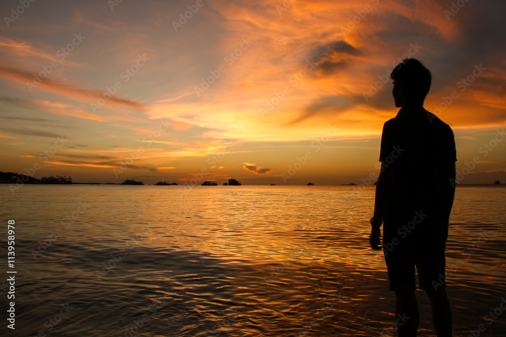 silhouette of man at sunset on the beach