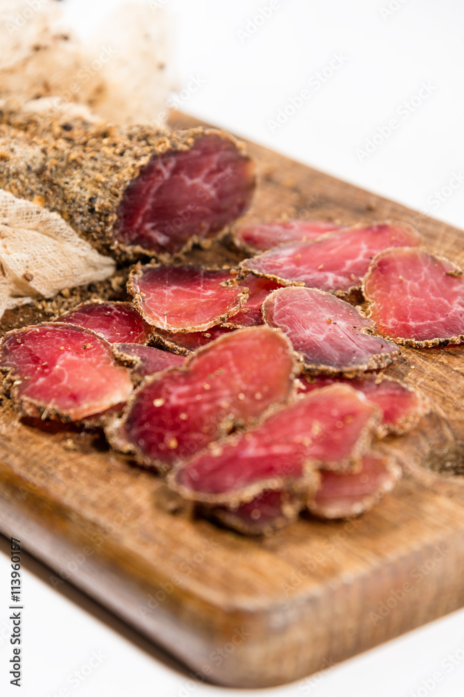 Various sliced meats on wooden serving board. Ham, pork or beef. Preparing for dinner. Selective focus. Various sliced meats on wooden serving board. Ham, pork or beef. Preparing for dinner. Selective focus.