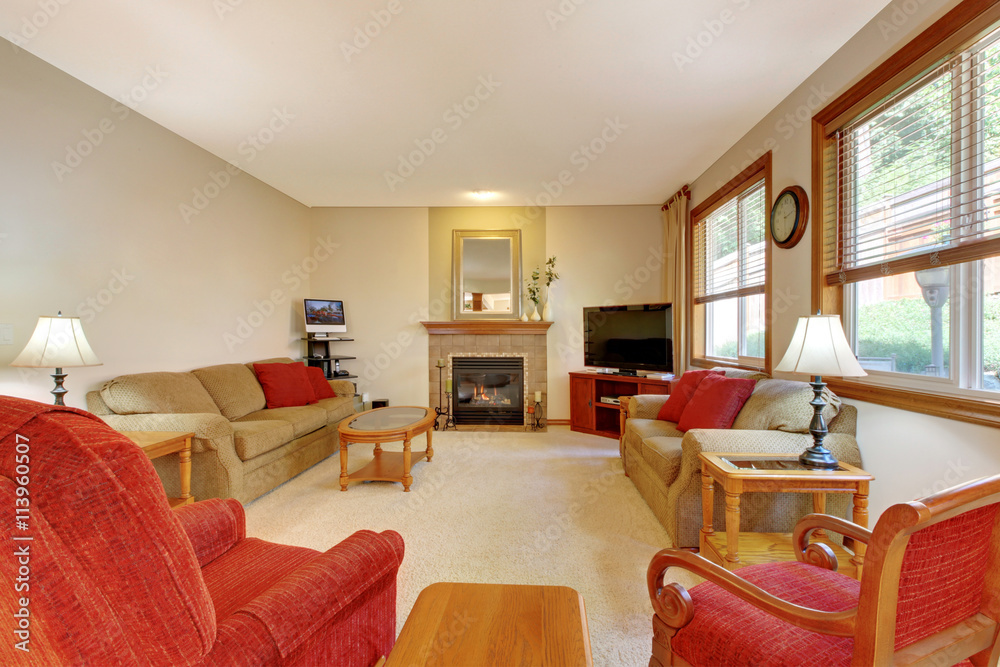 Fototapeta premium House interior. Peach and red living room with fireplace and red furniture.