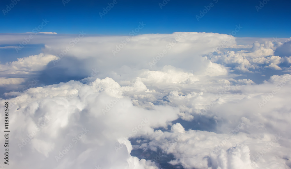 Fototapeta premium view from above the clouds sunny clear summer day