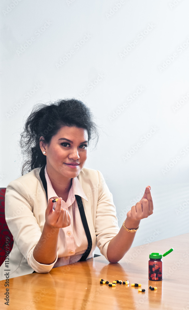 Woman compare two medicine capsules with hands Woman compare two medicine capsules with hands