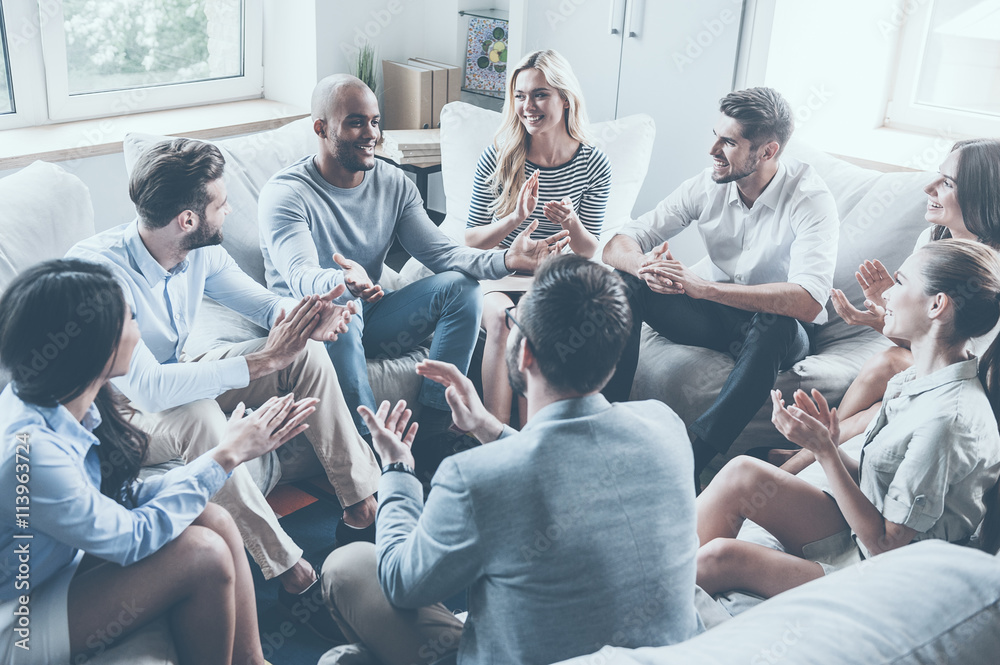 Applauding their achievements. 