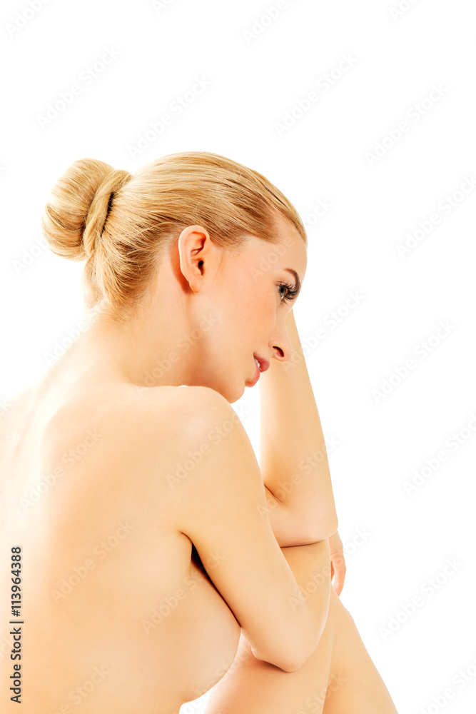 Young nude woman sitting on the floor Young nude woman sitting on the floor