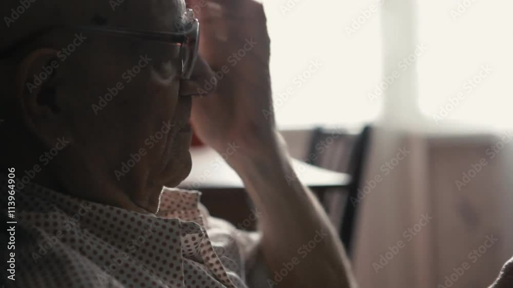 portrait of old man dressing glasses and using a smartphone at home, close up portrait of old man dressing glasses and using a smartphone at home, close up