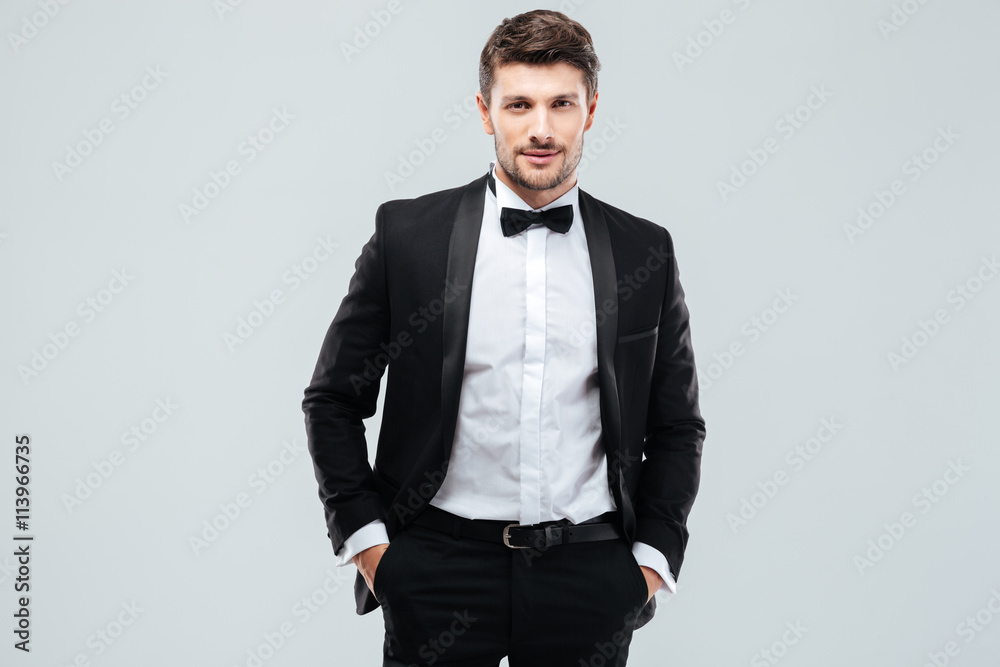 Fototapeta premium Confident young man in tuxedo with bowtie