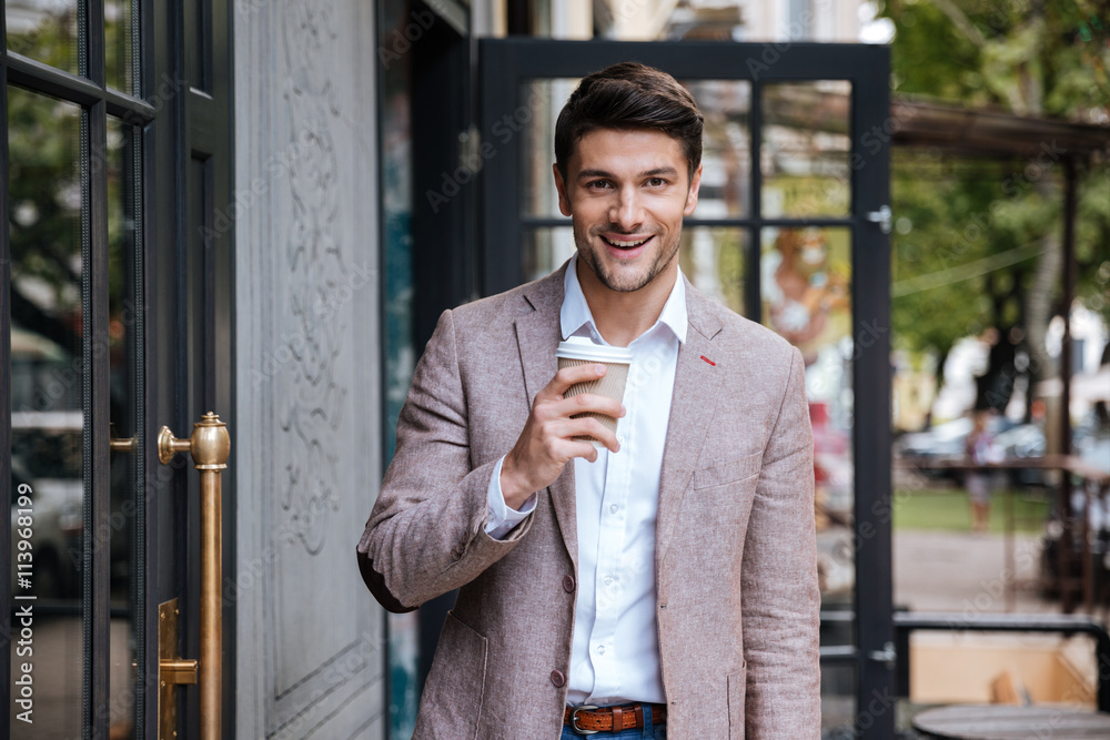 Young business man drinking a cup of coffee outdoors Young business man drinking a cup of coffee outdoors