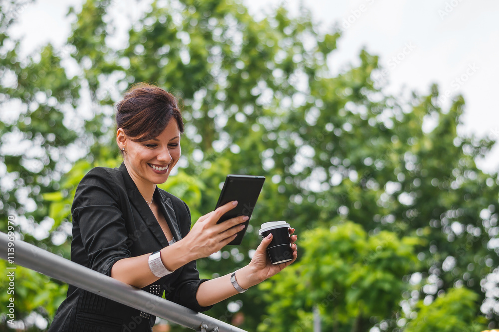Fototapeta premium Woman entrepreneur typing on tablet