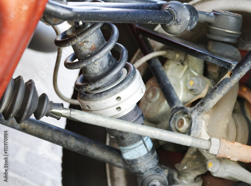 An old and dirty shock absorber cover with rust represent the car part. photo
