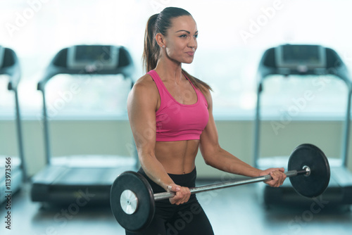 Woman Doing Heavy Weight Exercise For Biceps