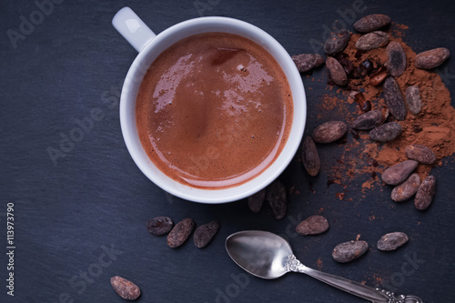 Hot chocolate and cocoa beans on the black background,