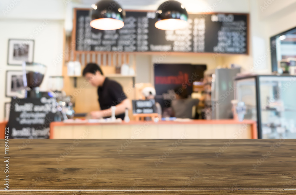 Obraz premium Selected focus empty brown wooden table and Coffee shop blur bac