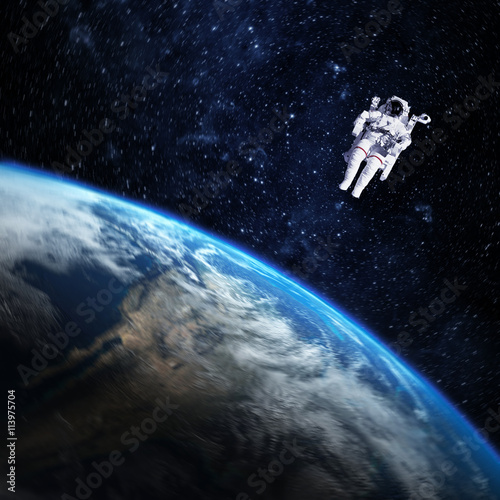 Astronaut in outer space against the planet earth. Elements of t
