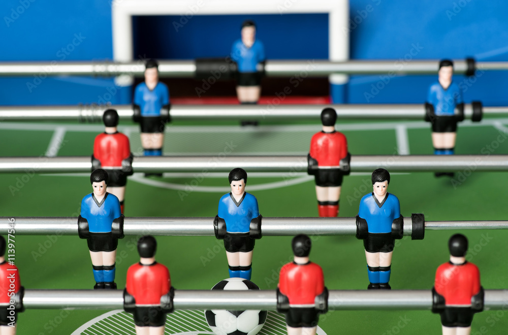 Red and blue players in a table football game Red and blue players in a table football game