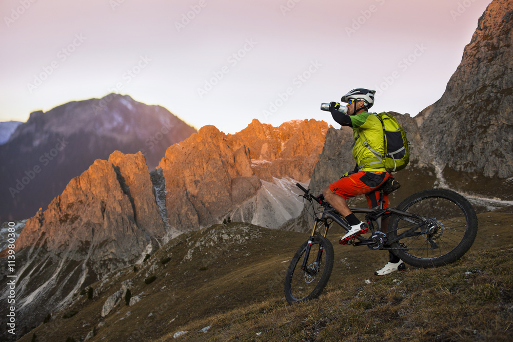 Fototapeta premium mountainbiker drinking from the bottle wheel