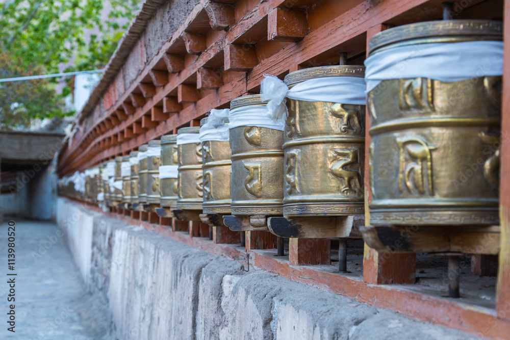 Prayer wheels, prayer's rolls of the faithful Buddhists.Line of Prayer wheels, prayer's rolls of the faithful Buddhists.Line of