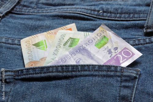 Swedish bank notes sticking up from a jeans pocket