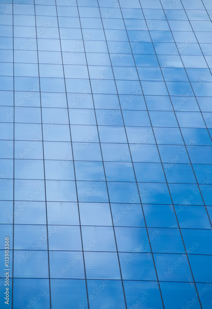 Reflection of blue sky on window glass office building