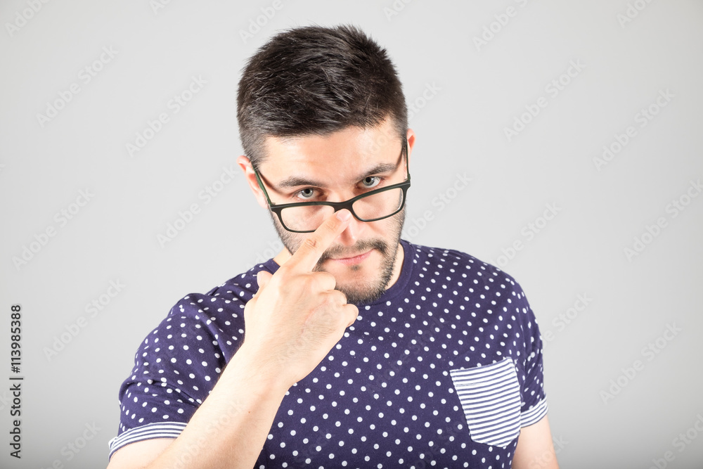 Man touching his glasses Man touching his glasses