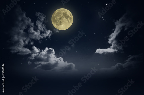 Beautiful magic blue night sky with clouds and fullmoon and stars