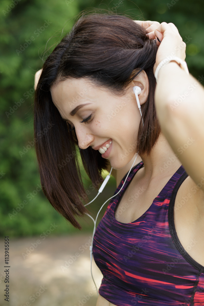 Sports woman listening to music and smile