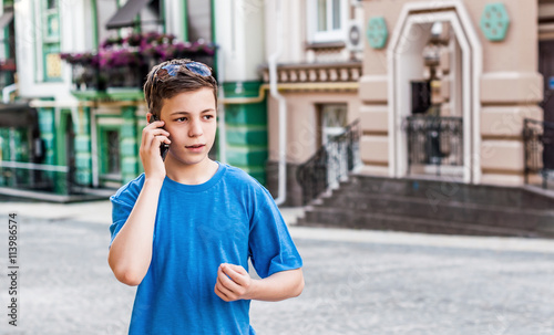 teenager with the phone on the street