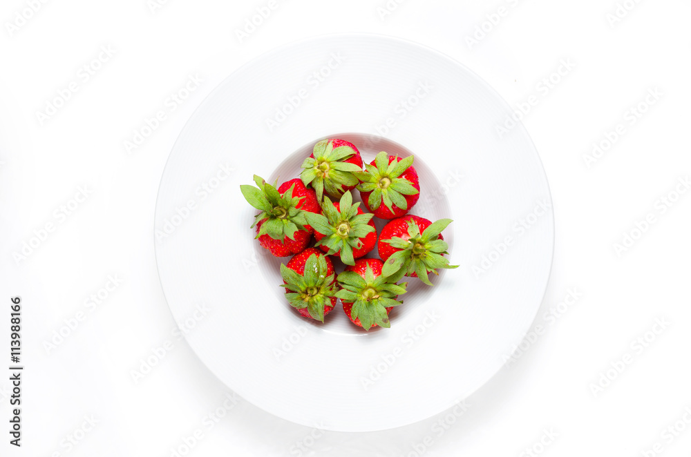 Fresh strawberries in a bowl on a white background from above Fresh strawberries in a bowl on a white background from above