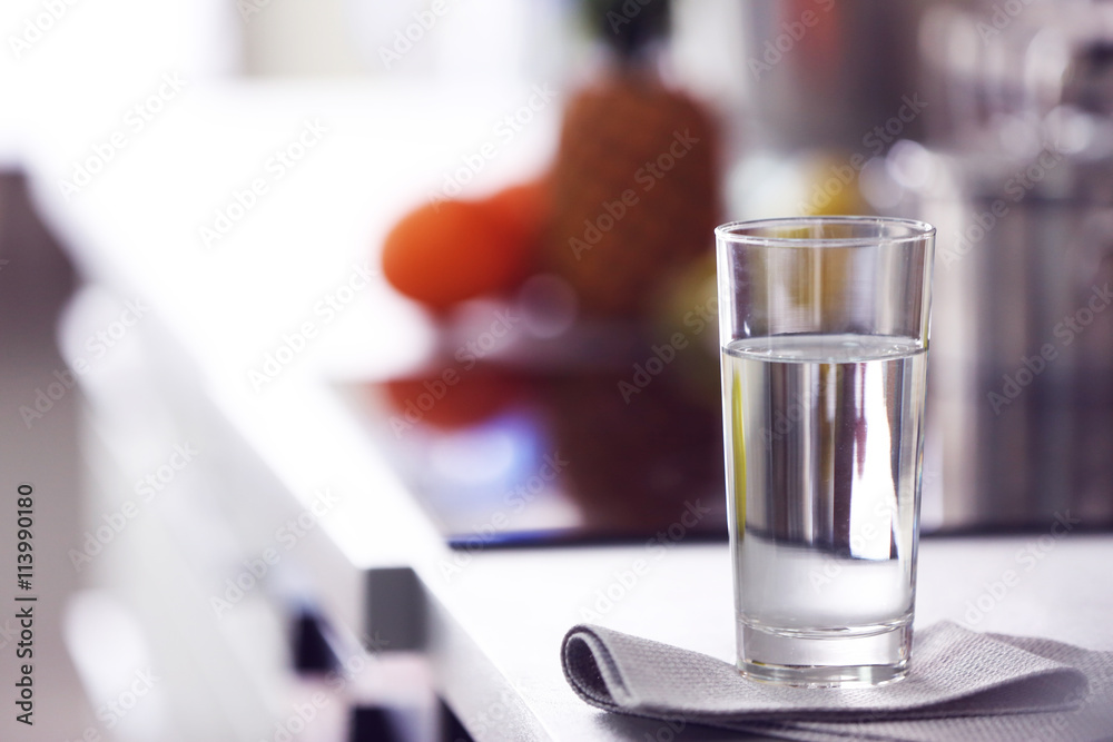 Glass of pure water on kitchen table Glass of pure water on kitchen table