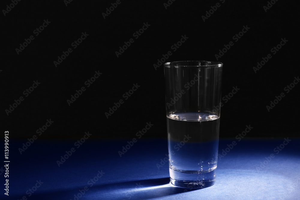 Glass of pure water on dark background Glass of pure water on dark background