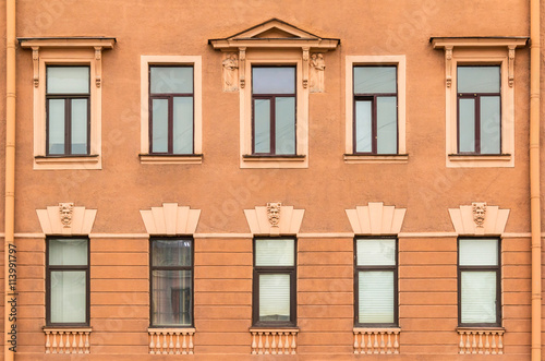 Several windows in a row on facade of urban apartment building front view, St. Petersburg, Russia. © dr_verner