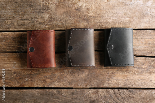 Few leather wallets on wood...