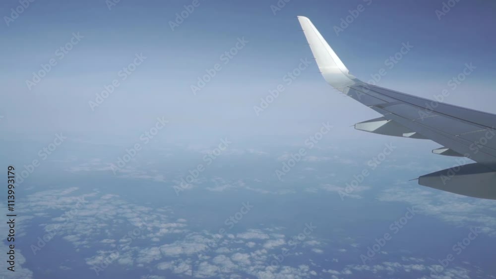 Airliner flying high above the clouds. Porthole view, aerial video Airliner flying high above the clouds. Porthole view, aerial video