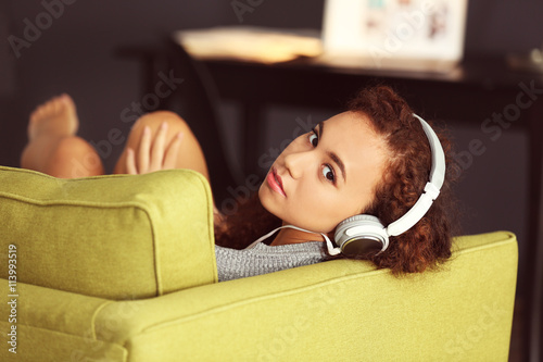 Relaxed young woman listeni...