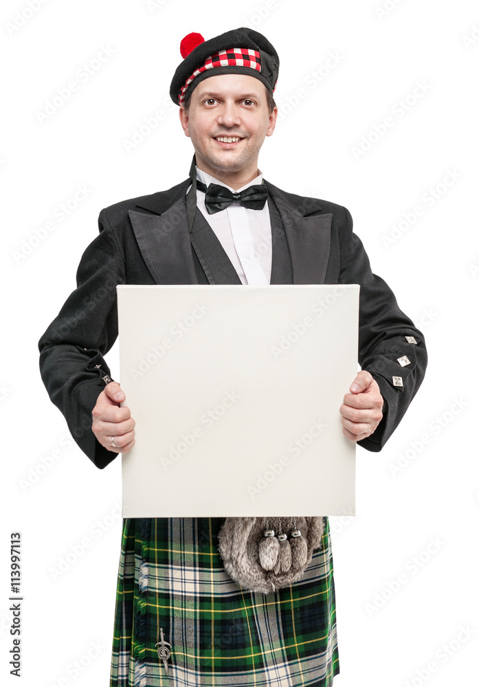 Scottish man in traditional national costume with empty banner Scottish man in traditional national costume with empty banner