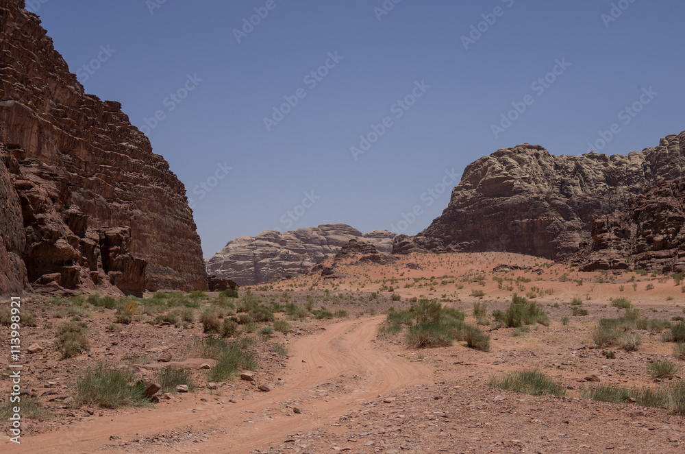 Road thru desert and rocks of Wadi Rum (Valley of the Moon), Jordan Road thru desert and rocks of Wadi Rum (Valley of the Moon), Jordan