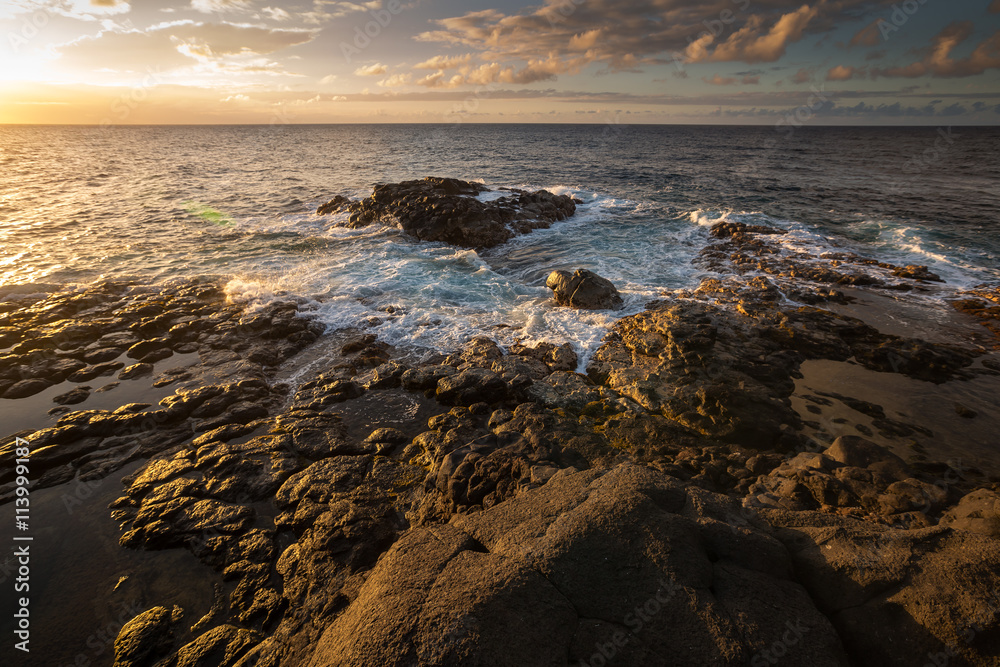 Sunset along the Queens Bath area of Kauai, Hawaii