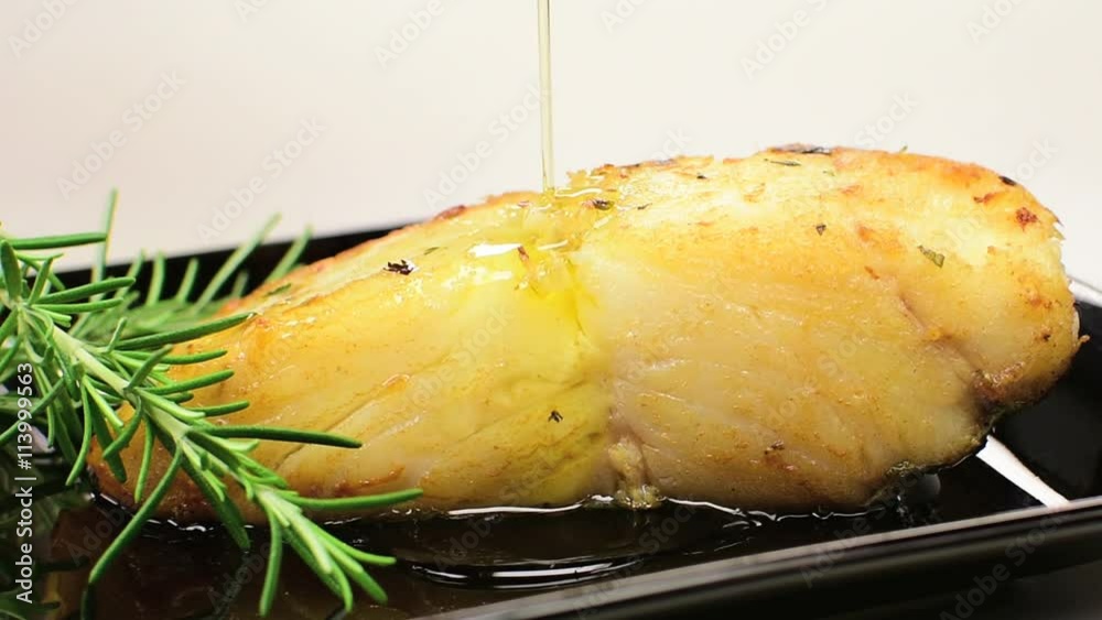 Pouring olive oil in cod fish 