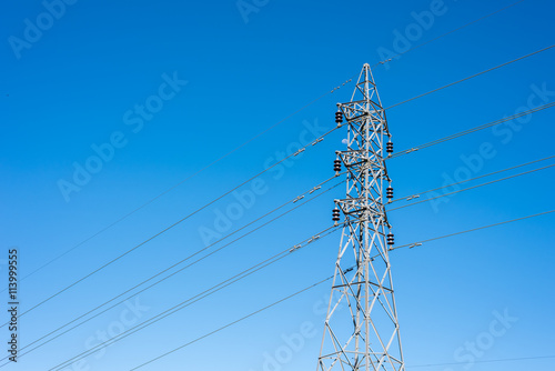 High voltage post on blue sky background