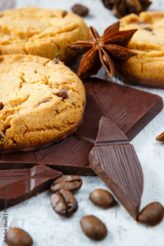 Chocolate cookies with chocolate chips, coffe beans and anise on the light wooden background Chocolate cookies with chocolate chips, coffe beans and anise on the light wooden background