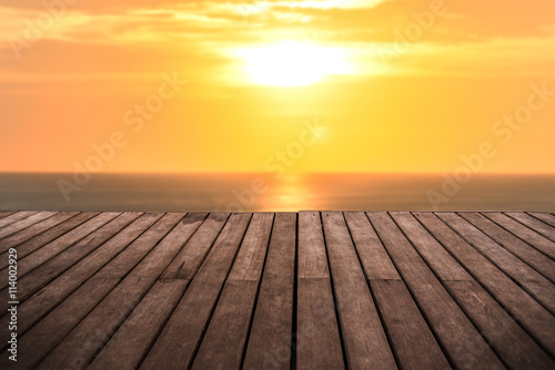 perspective empty wooden terrace with sunset on sea background